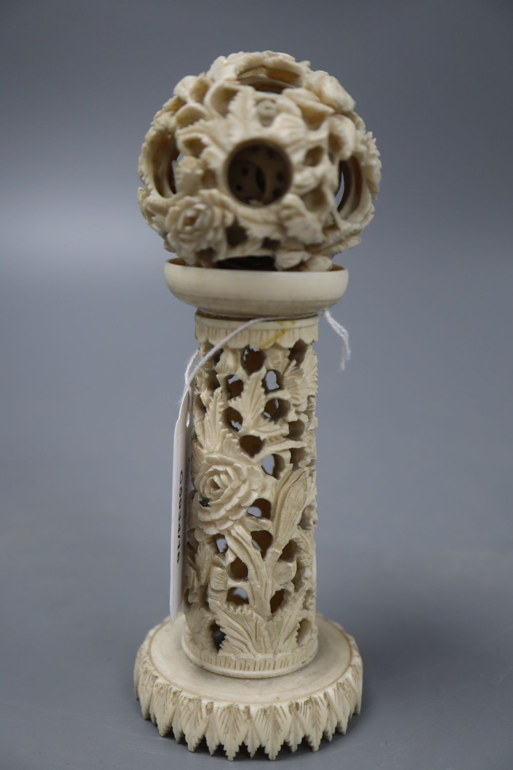 An ivory concentric puzzle ball on stand, overall height 15cm